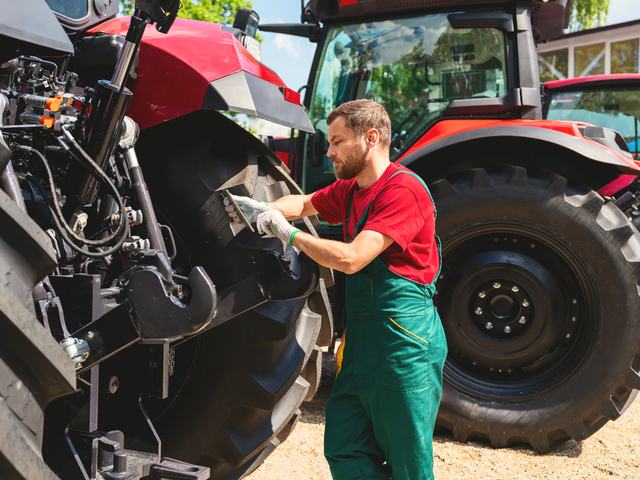 Fitter checking a tractor tyre