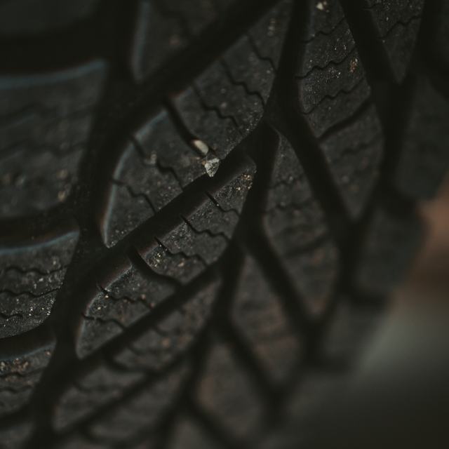 Close-up of a stone caught in a tyre tread