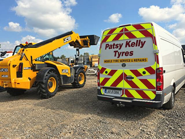 The Patsy Kelly Tyres van parked beside a JCB telehandler on a building site