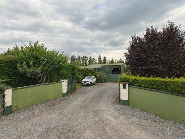 The gates and driveway up to the Patsy Kelly Tyres yard at Balitallion